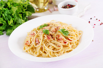 Classic homemade carbonara pasta with pancetta, egg, hard parmesan cheese and cream sauce. Italian cuisine. Spaghetti alla carbonara.
