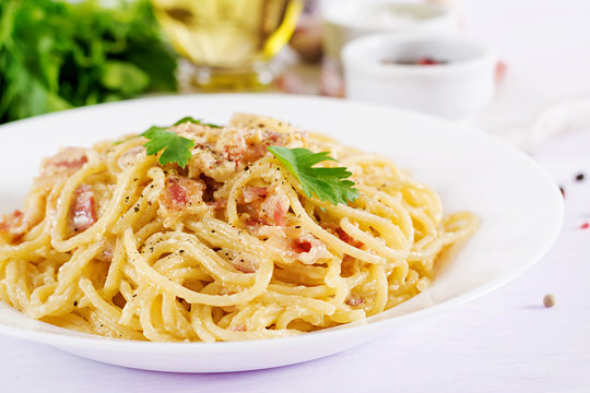 Classic homemade carbonara pasta with pancetta, egg, hard parmesan cheese and cream sauce. Italian cuisine. Spaghetti alla carbonara.