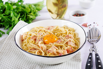 Classic homemade carbonara pasta with pancetta, egg, hard parmesan cheese and cream sauce. Italian cuisine. Spaghetti alla carbonara.
