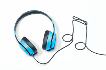 Headphones and Musical note made of earphones wire. 3d rendering.