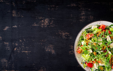 Tomato salad with mix micro greens and  camembert cheese. Top view
