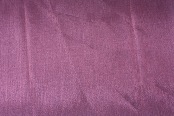 Fototapeta na wymiar closeup photo of a purple, silky, satin background