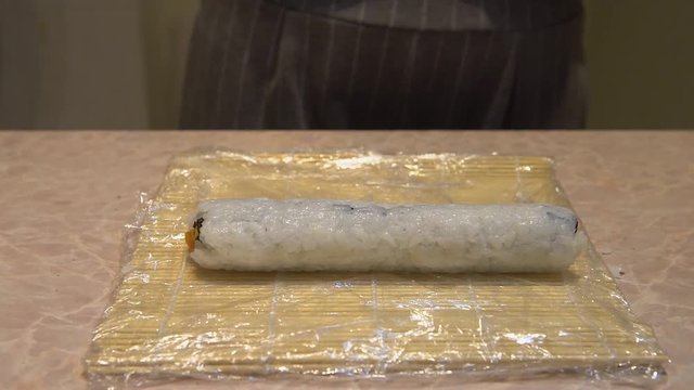 Close up of a woman preparing homemade sushi