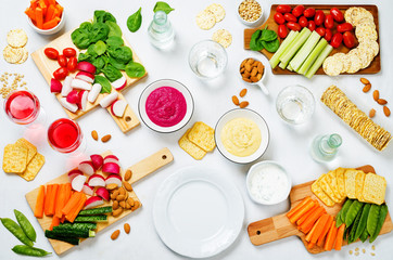 Variation of healthy vegan snacks. Vegetables, crackers, dip and hummus