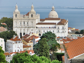 City scene with large church near the waterfront in Lisbon Portugal.
