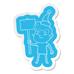 happy cartoon  sticker of a man with sign wearing santa hat