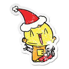 distressed sticker cartoon of a robot wearing santa hat