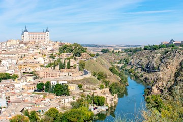 A panoramic view of the old city of Toledo, with it’s castle inside the city walls, surrounded by a ravine and river that serves as a moat.
