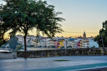The colourful houses of Triana on the far-side of the river Guadalquivir at dawn in Seville, Spain