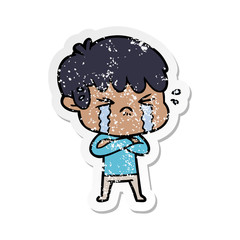Obraz premium distressed sticker of a cartoon boy crying