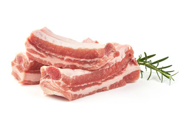 Raw pork ribs with rosemary, close-up, isolated on white background