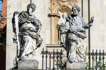 Krakow. In the lower part of the facade of the Cathedral of Saints Peter and Paul there are 4 statues of the most famous Jesuits, above the entrance there is an emblem of the Jesuit Order.