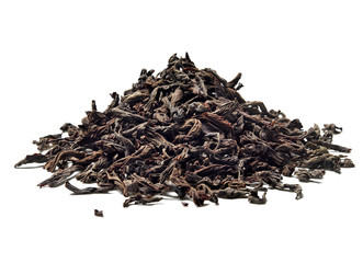 Heap of black leaf tea on white background. Close up. High resolution.