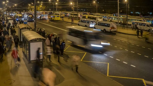 passengers waiting and boarding buses at the bus terminal, time lapse