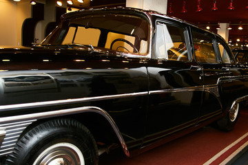 Renovated black retro car in the museum.