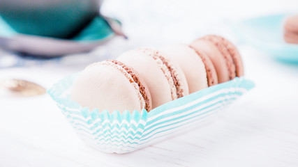 French dessert chocolate and vanilla macaroons on a white background. 16:9