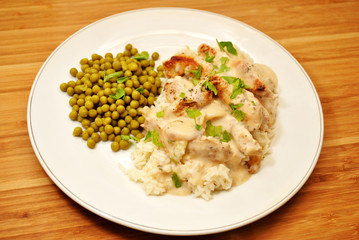 Pork with Cream Sauce Over White Rice & a Side Dish of Peas