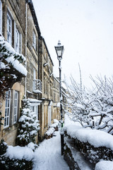 A view along the houses of Tory, Bradford on Avon, during snowy weather with a old fashioned styled street lamp © Starsphinx
