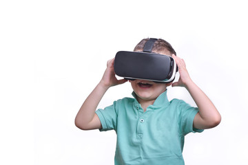 Amazed teen boy wearing virtual reality goggles watching movies or playing video games, isolated on white. Surprised teenager looking in VR glasses. Emotional portrait of child experiencing 3D gadget