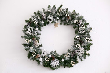 Decorative Christmas wreath decorated with toys and fir cones