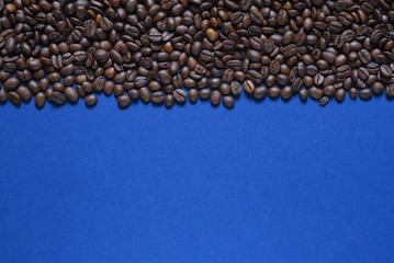 Roasted coffee beans on a blue background 