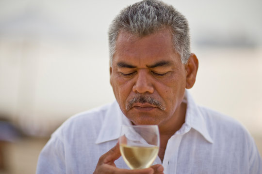 Man sniffing wine before tasting it