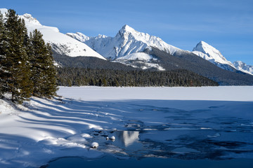 The frozen Maligne Lake with Queen Elizabeth Ranges in the background in the Jasper National Park