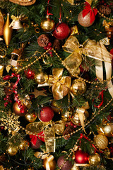Luxury Christmas tree with garland and balls of red and gold color