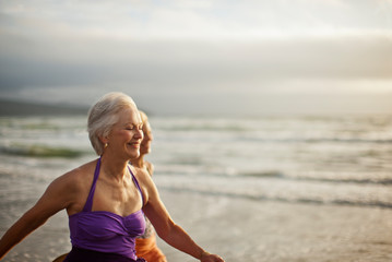 Smiling mature women enjoying beach
