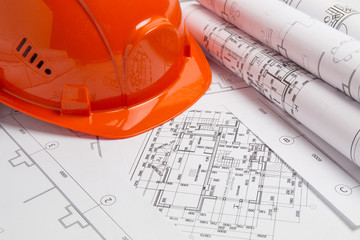 Paper architectural drawings, blueprint and helmet. Engineering blueprint