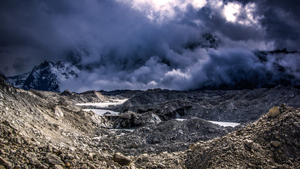 Landscape view of Khumbu Glacier with many dark clouds. Bad weather.  Sagarmatha (Everest) National Park, Nepal.