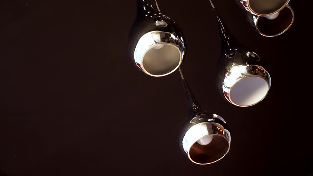 modern beautiful chrome lamp on a dark ceiling
