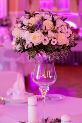 Banquet decorated table, with cutlery. Wedding decor in the banquet hall. Serving of a festive table, plate, napkin, knife, fork. Table setting decoration. Romantic Dinner or other events - wedding.