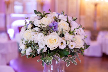 Banquet decorated table, with cutlery. Wedding decor in the banquet hall. Serving of a festive table, plate, napkin, knife, fork. Table setting decoration. Romantic Dinner or other events - wedding.