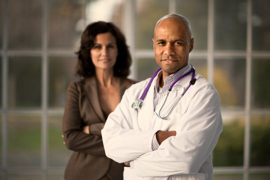 Portrait of two smiling mid adult doctors.
