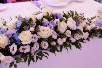 Banquet decorated table, with cutlery. Wedding decor in the banquet hall. Serving of a festive table, plate, napkin, knife, fork. Table setting decoration. Romantic Dinner or other events - wedding.