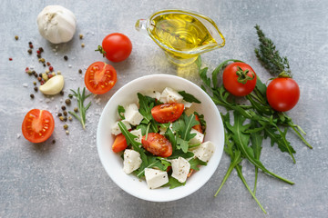 Italian cuisine. Vegetarian food. Salad with mozzarella, arugula and cherry tomatoes.