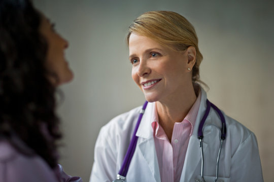 Smiling doctor speaking with colleague