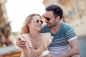 Couple drink coffee outside