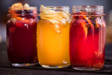 Three glass jars with delicious hot winter beverages close