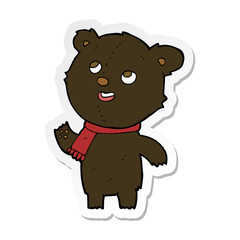 sticker of a cartoon black bear wearing scarf