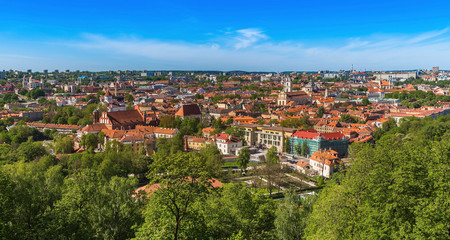 Fototapeta premium Vilnius city with tiled roofs cathedrals and churches modern buildings on the horizon