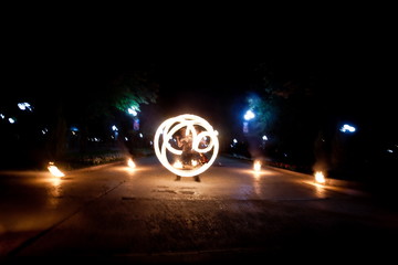 Amazing fire show dance. Fire dancer playing with flame