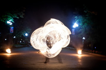 Amazing fire show dance. Fire dancer playing with flame