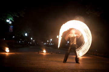 Amazing fire show dance. Fire dancer playing with flame