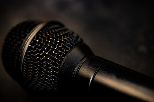 Black microphone close up with a smoke background