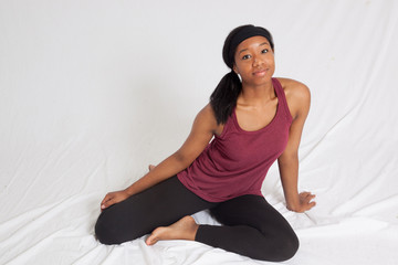 Happy Black woman in exercise outfit sitting