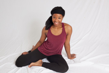 Fototapeta premium Happy Black woman in exercise outfit sitting