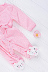 Pink fleece pajama and pacifier.