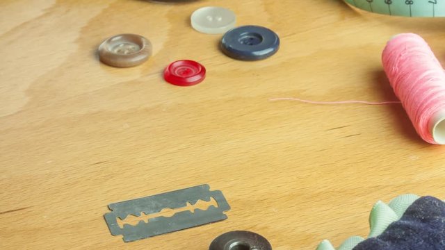 Tailoring Close Up - moving sewing accessories on wooden desk, stop motion